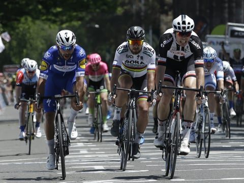Fernando Gaviria, left, and Maximilian Walscheid, right, cross the finish line on the final day of the Amgen Tour of California cycling race Saturday, May 19, 2018, in Sacramento, Calif. Bernal Gomez won the overall race. 